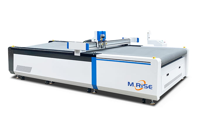 Industrial CNC digital knife cutter with oscillating blade precision-cutting stacked denim fabric layers